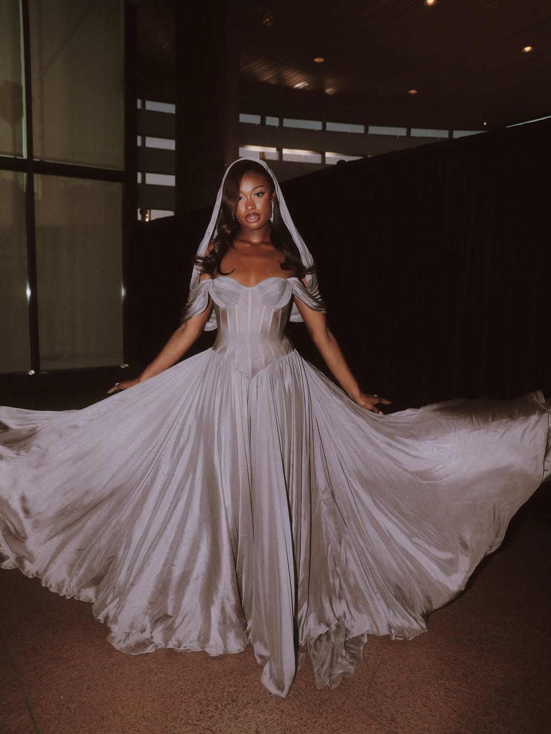 Coco Jones wearing a grey Andrew Kwon gown at the Los Angeles premiere of the A24 film The Drama.