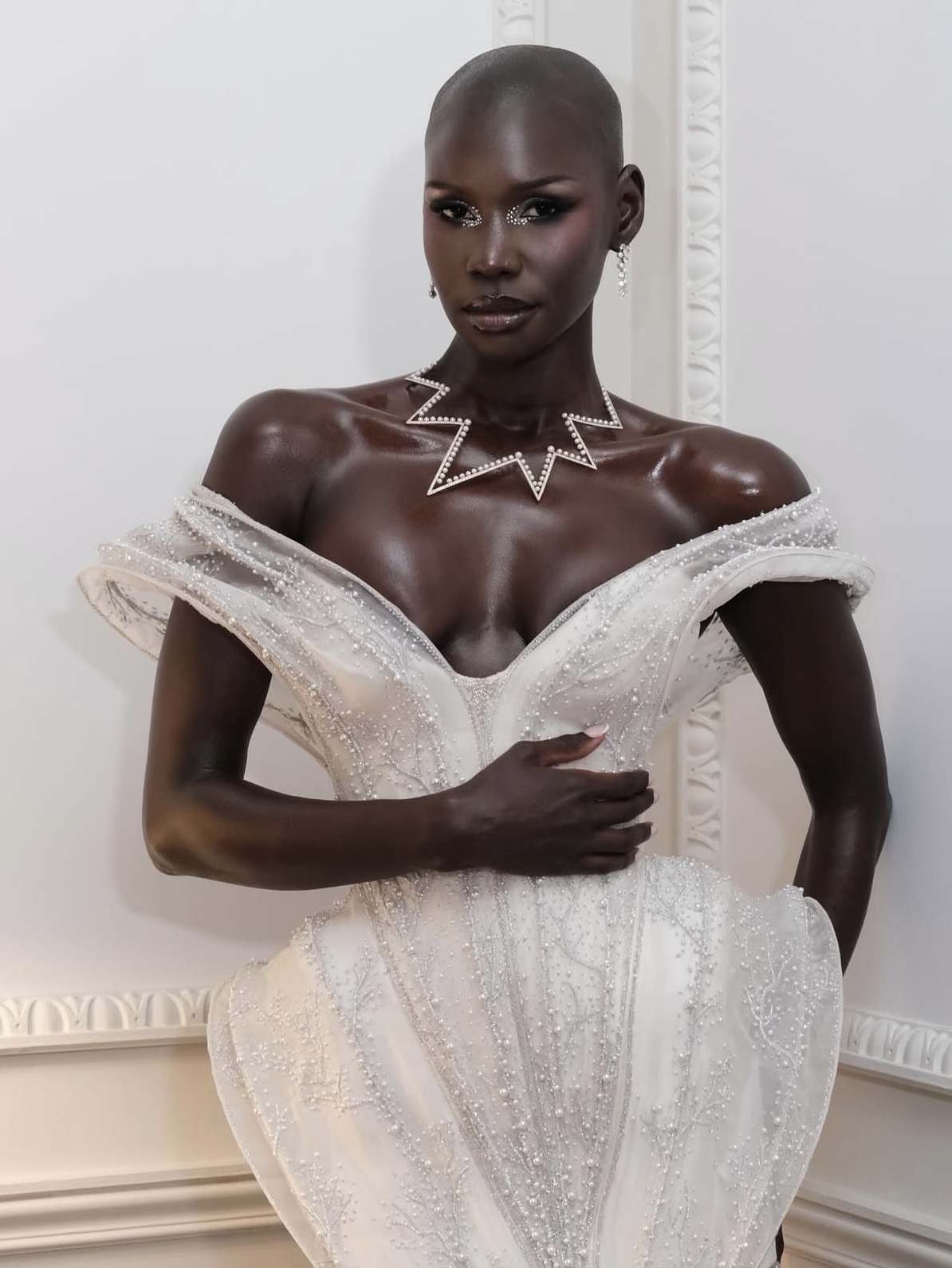 Adot Gak's editorial beauty look featuring crystal eye embellishments and radiant skin