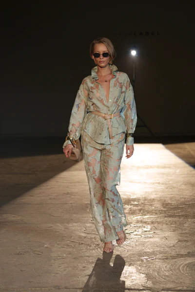 woman wearing lace sage green pants set in spring