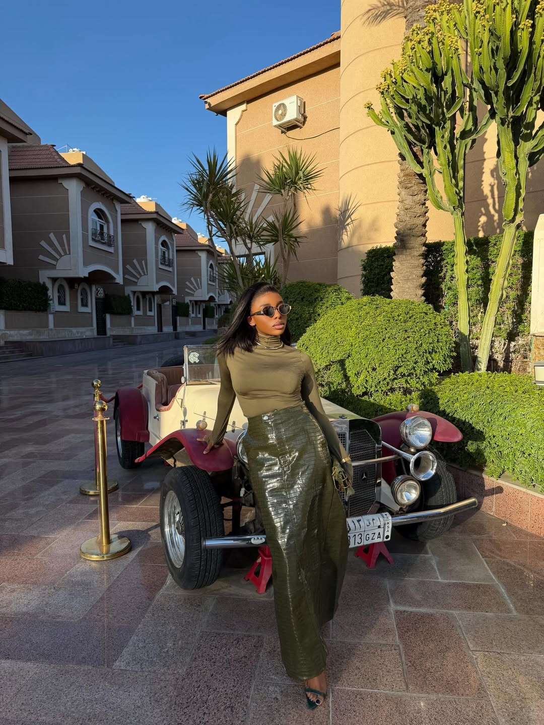 woman wearing green leather skirt with a turtleneck top elevated wardrobe basics