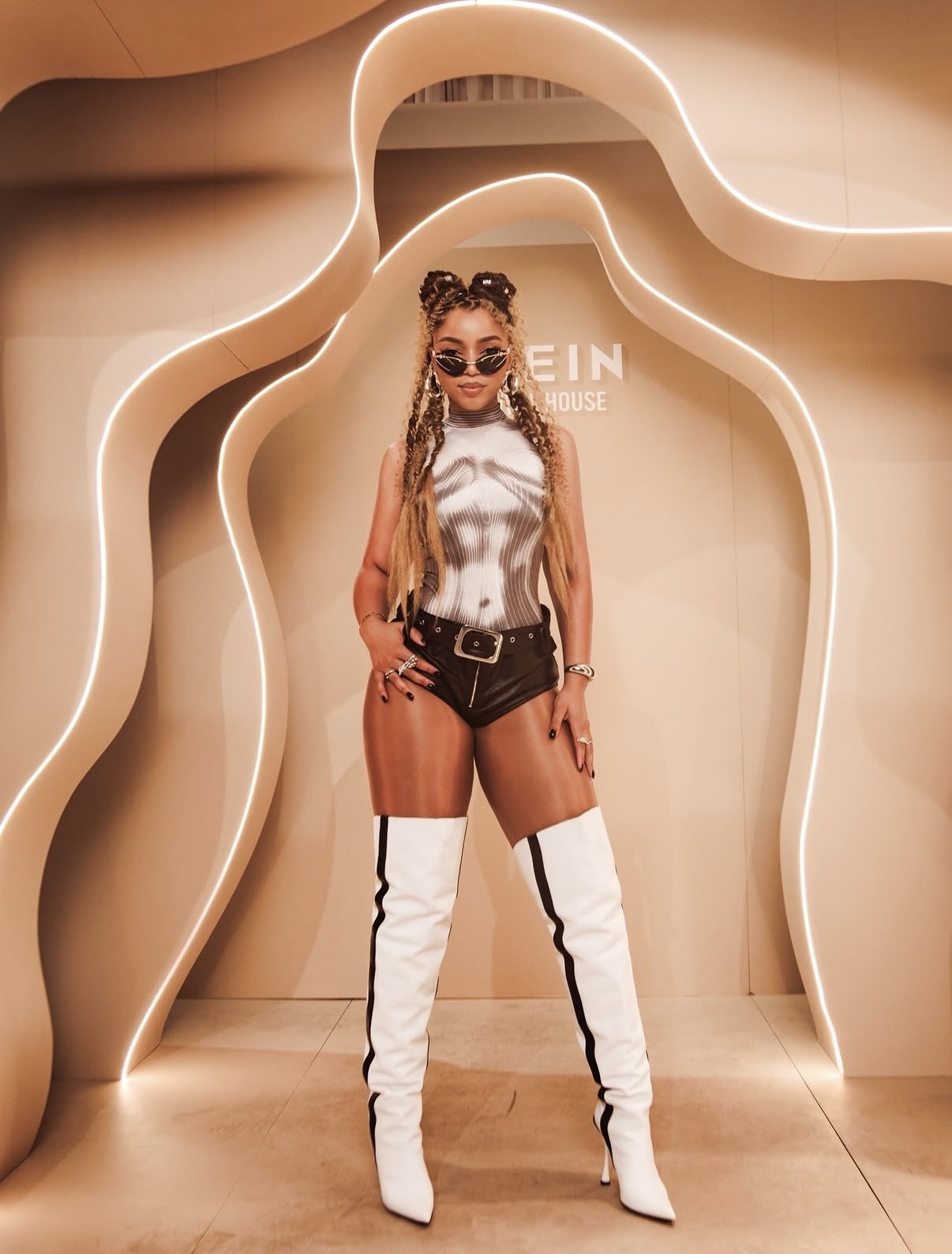 Chloe Bailey in a graphic corset-print bodysuit with leather shorts and white over-the-knee boots — best celebrity fashion moments