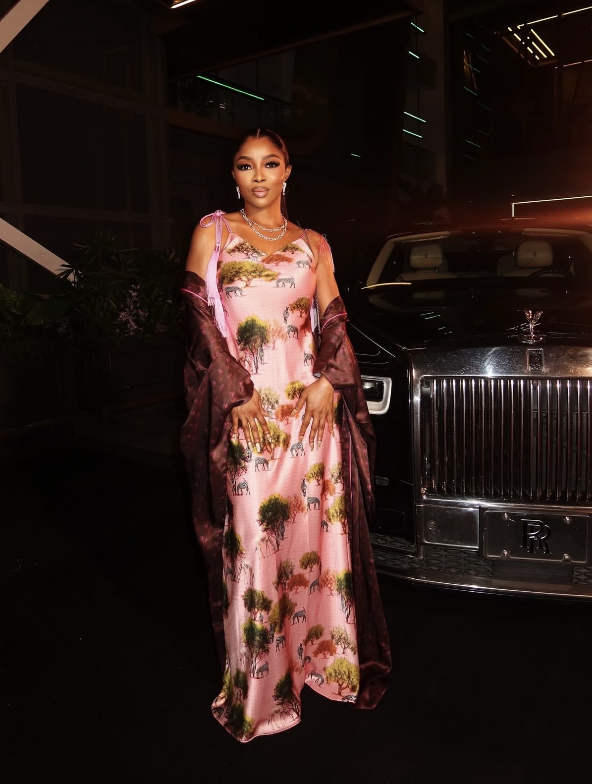 Toke Makinwa in printed silk slip dress and robe highlighting relaxed, elegant Nigerian styles