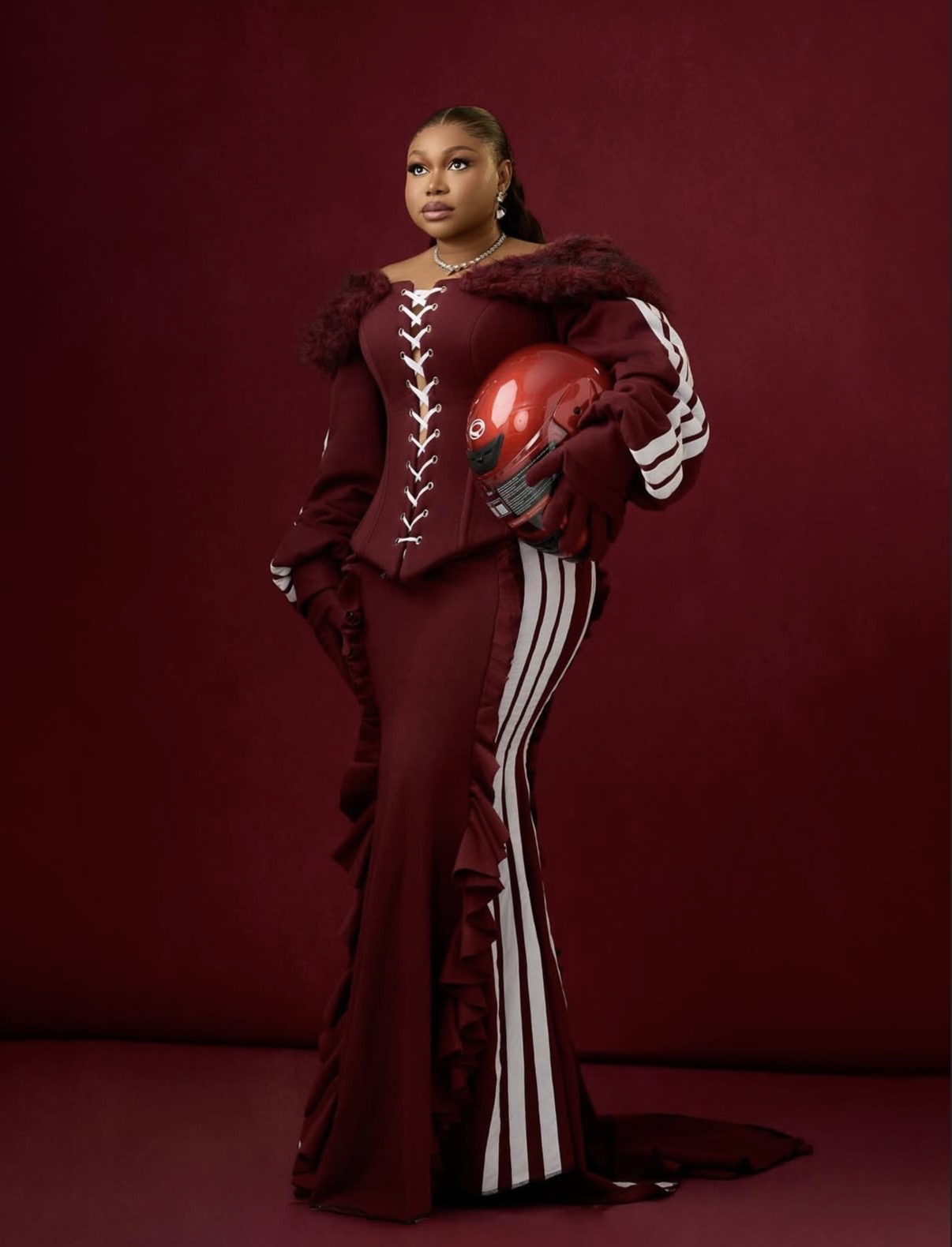 Ruth Kadiri in maroon sporty-inspired gown blending dramatic elements with Nigerian elegant styles