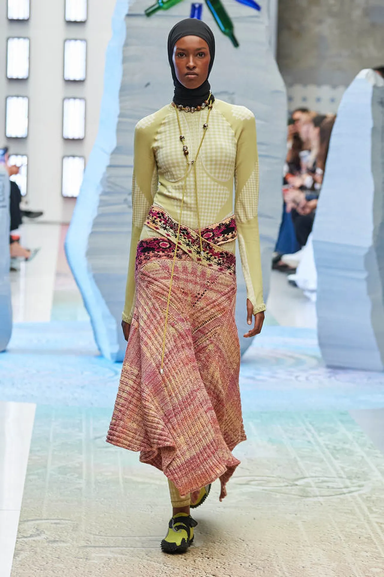 Paolina Russo Autumn Winter 2026 collection preppy pleated skirts and badge-covered silhouettes