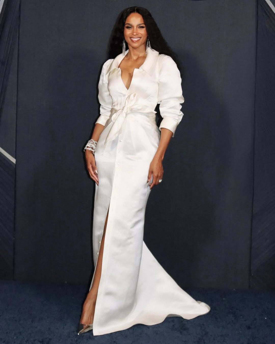 Ciara in a sleek, glam look with soft waves and radiant makeup.