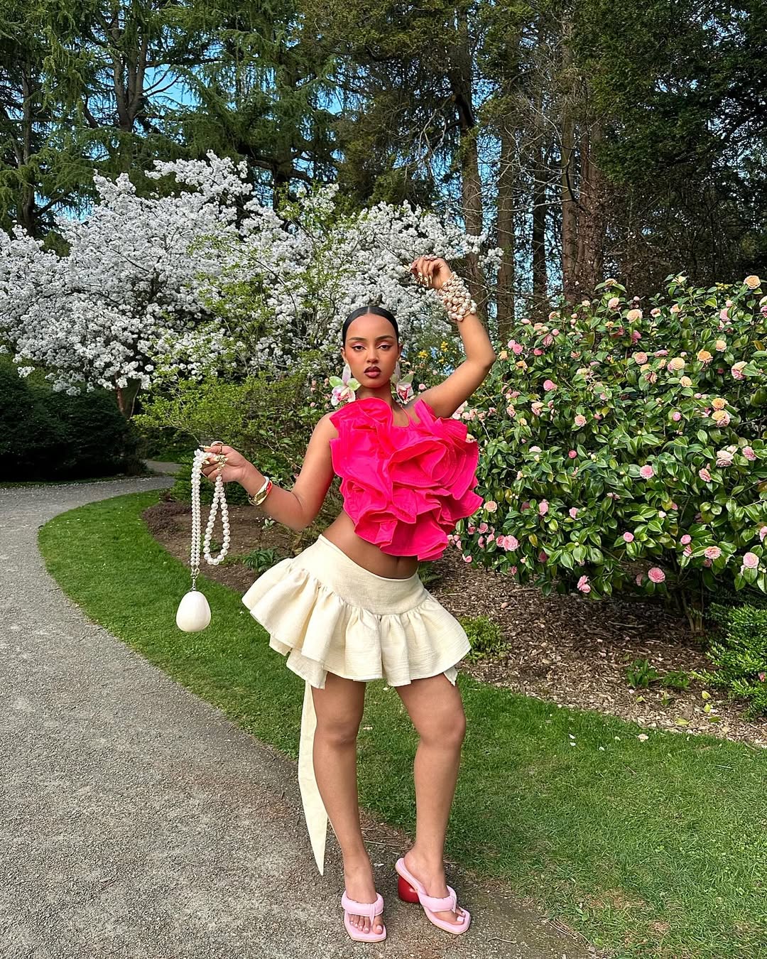 woman wearing rosette detailed top and ruffle mini skirt in new fashion romantic era