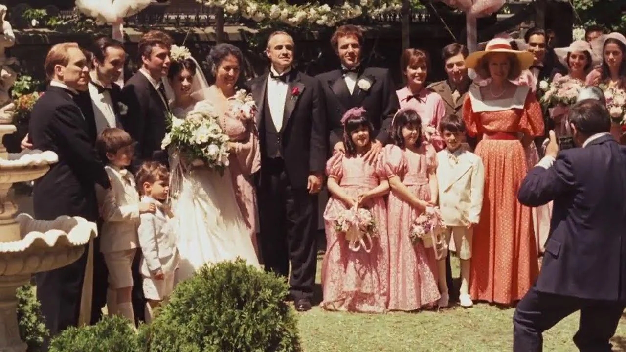 The Corleone family celebrates the wedding of Connie Corleone in their family compound. 