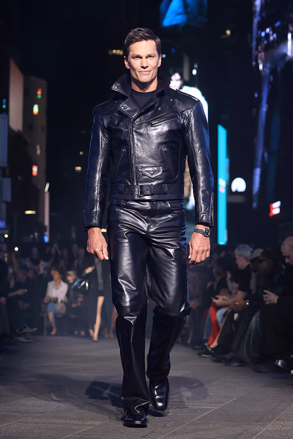 Tom Brady walking Gucci Cruise 2027 runway in all-leather look Times Square 2026