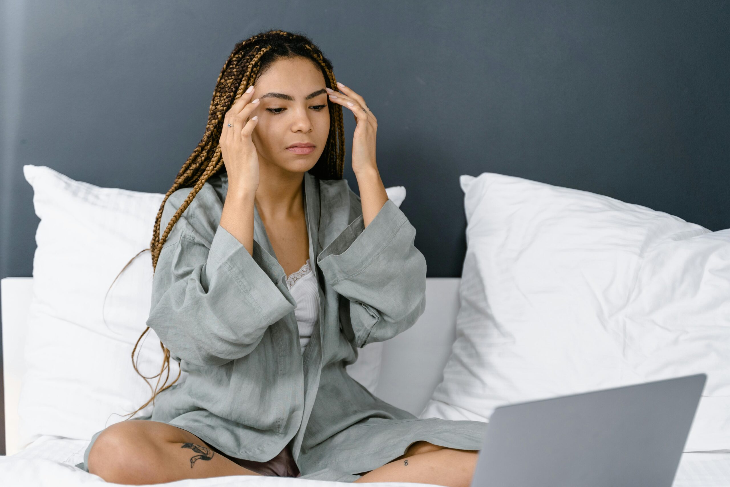 woman with brain fog sitting on bed