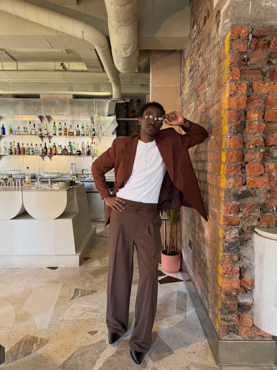 Man in unstructured brown, earth toned blazer, representative of the business casual blazer trend of 2026, oversized polished