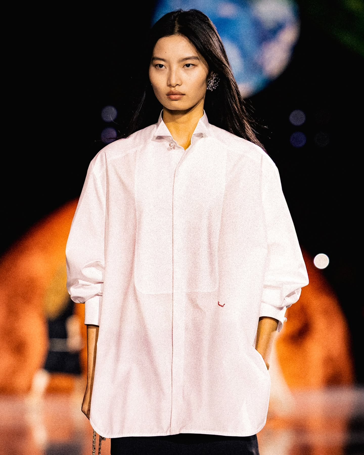 A model wearing the Charvet x Chanel oversized button-up shirt from the Spring Summer 2026 collection