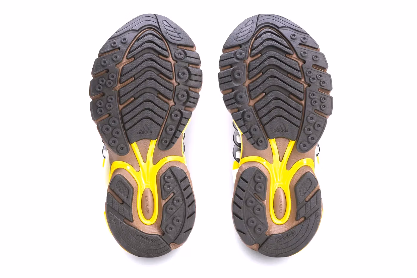 Official product shot of the Pharrell adidas Adistar Jellyfish Timber KK2889 showing the brown mesh base with electric yellow cage accents