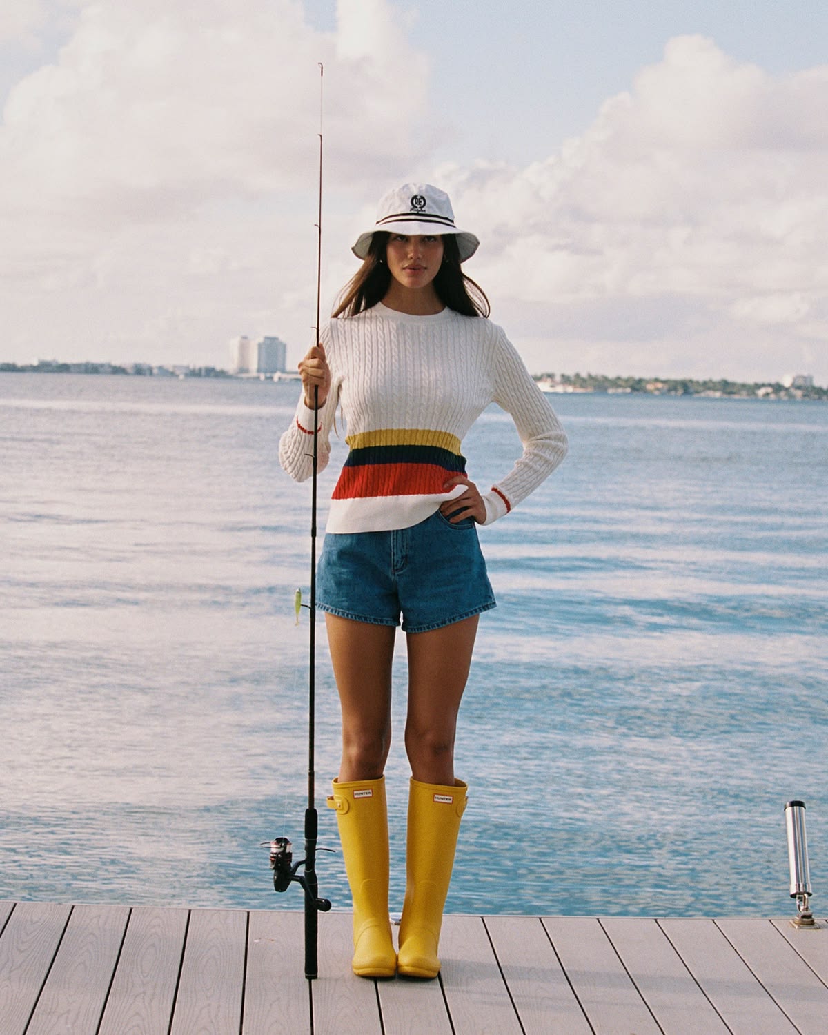 woman wearing sweater with denim shorts fisherman aesthetic