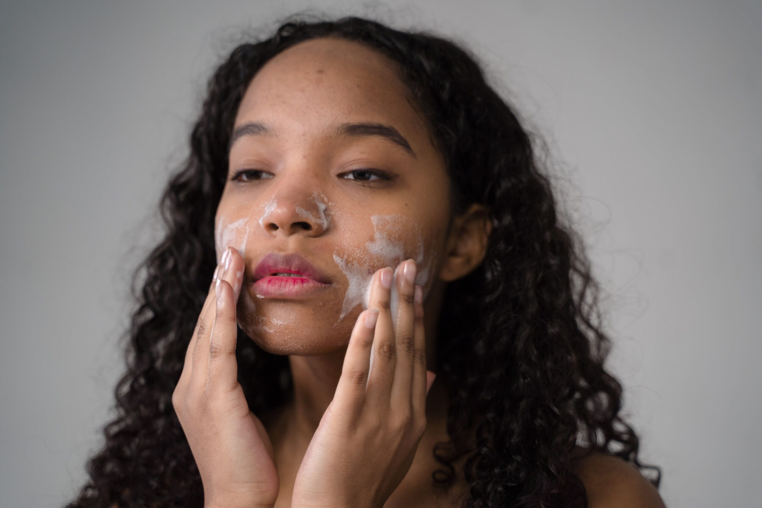woman layering skincare products