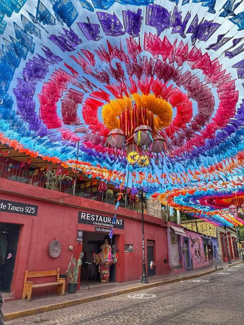 A Día de Muertos celebration in Oaxaca Mexico decorated with marigolds candles and photographs during the November celebration