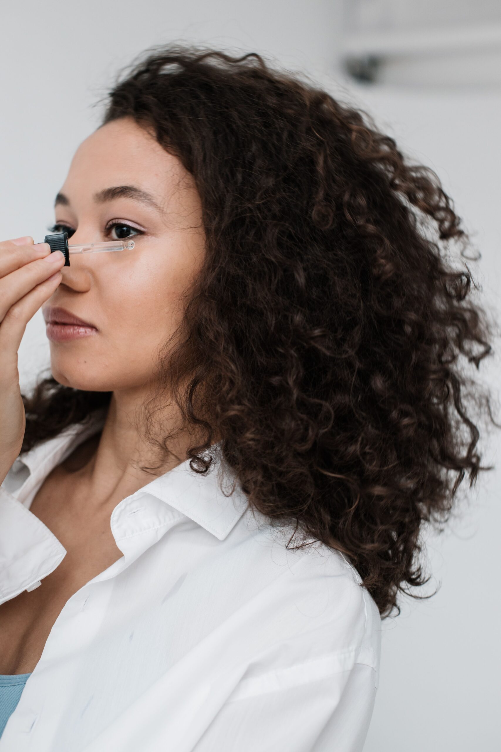 woman using eye serums on under eye