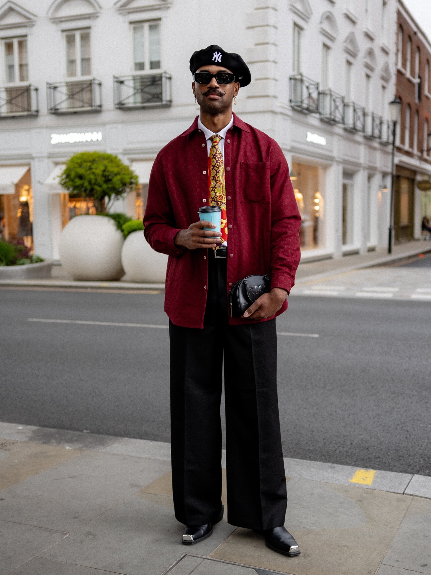 Man wearing an untucked oxford shirt under a jacket, shirt-out styling